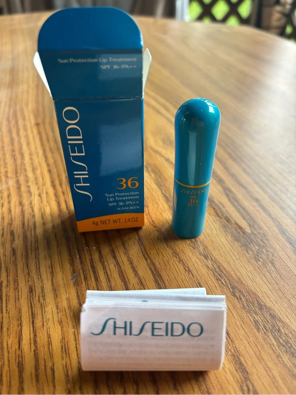Shiseido Sun Protection Lip Treatment SPF 36 - 14 oz. Teal and Gold